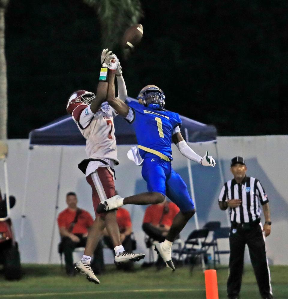 Mainland High School player (1) Zavier Mincey blocks the ball from Raines player (2) Ty'ren Randolph. 