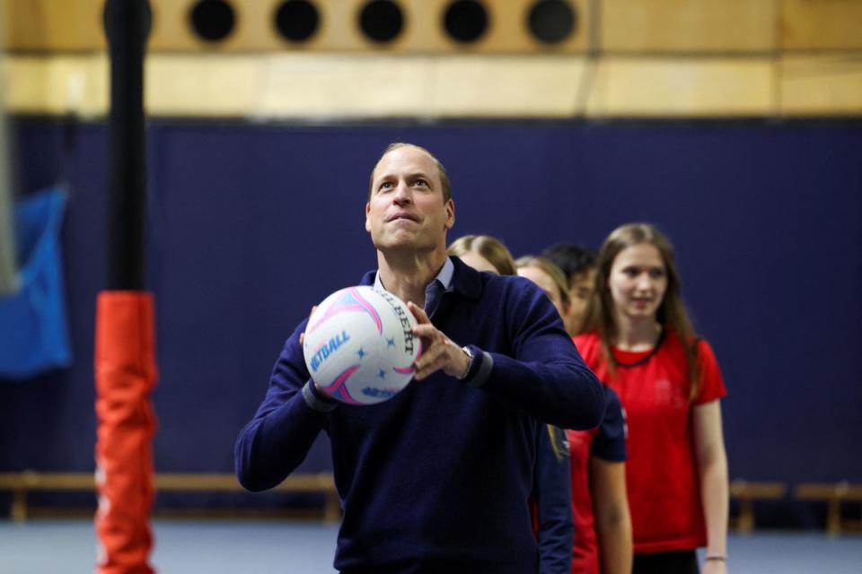 The Prince of Wales went head-to-head with his wife in netball drills (PA)