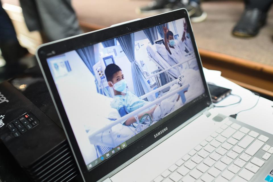 A laptop projecting video of the rescued soccer players at a press conference in Mae Sai, Thailand, July 11. The Wall Street Journal reported that their coach taught them meditation techniques to try to keep them calm. (Ye Aung Thu / Getty Images)