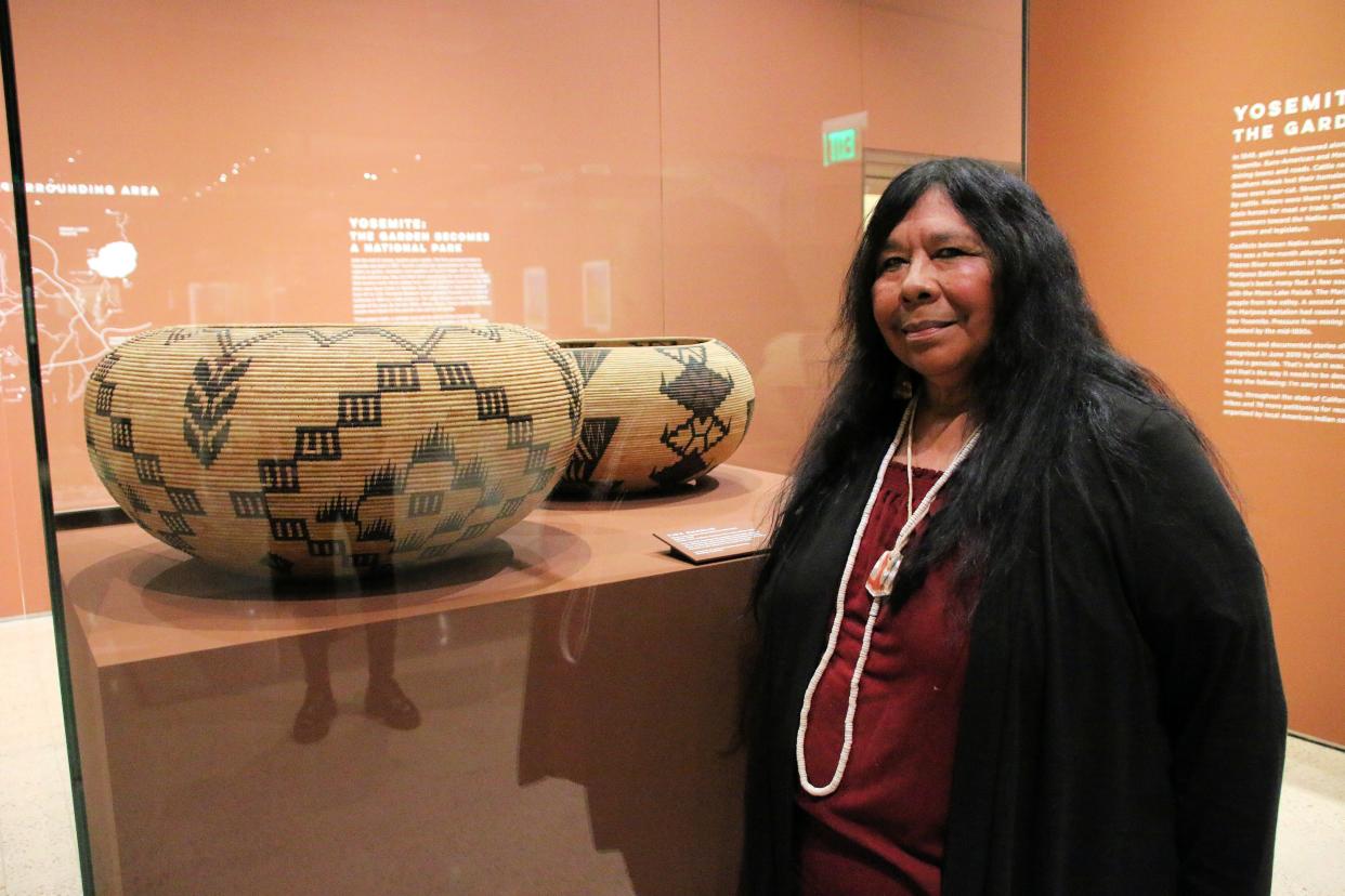 Lucy Parker looks at baskets made by her great-grandmother Lucy Telles during an exhibit at the Heard Museum in March 2020. Parker, Miwok/Paiute/Kashaya Pomo, grew up in Yosemite National Park because her father worked there.