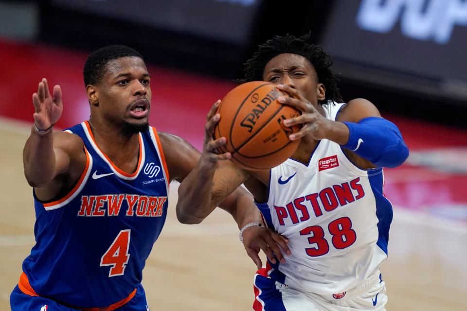 Detroit Pistons guard Saben Lee (38) attempts a layup as New York Knicks guard Dennis Smith Jr. defends during the second half of a preseason NBA basketball game Friday, Dec. 11, 2020, in Detroit.