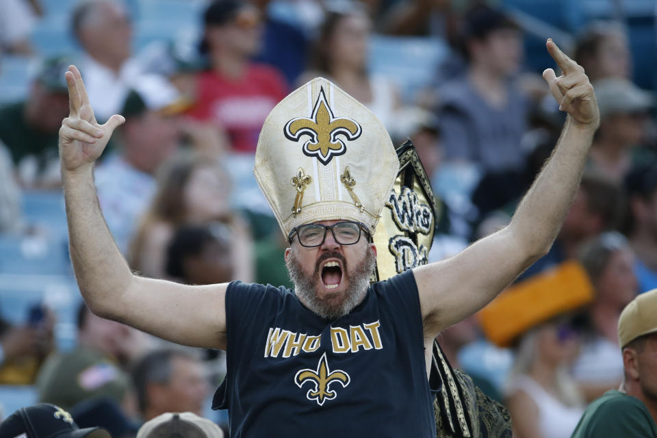 A New Orleans Saints fan cheers during the second half of an NFL football game between the New Orleans Saints and the Green Bay Packers, Sunday, Sept. 12, 2021, in Jacksonville, Fla. (AP Photo/Stephen B. Morton)