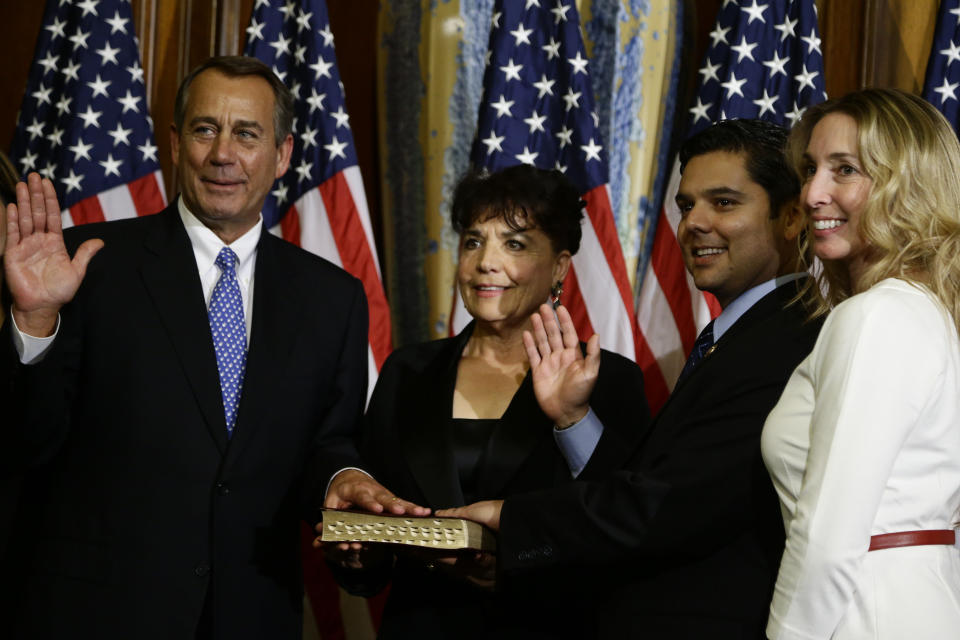 House Speaker John Boehner of Ohio performs a mock swearing in for Rep. Raul Ruiz, D-Calif., second right, Thursday, Jan. 3, 2013, on Capitol Hill in Washington as the 113th Congress began. (AP Photo/Charles Dharapak) 