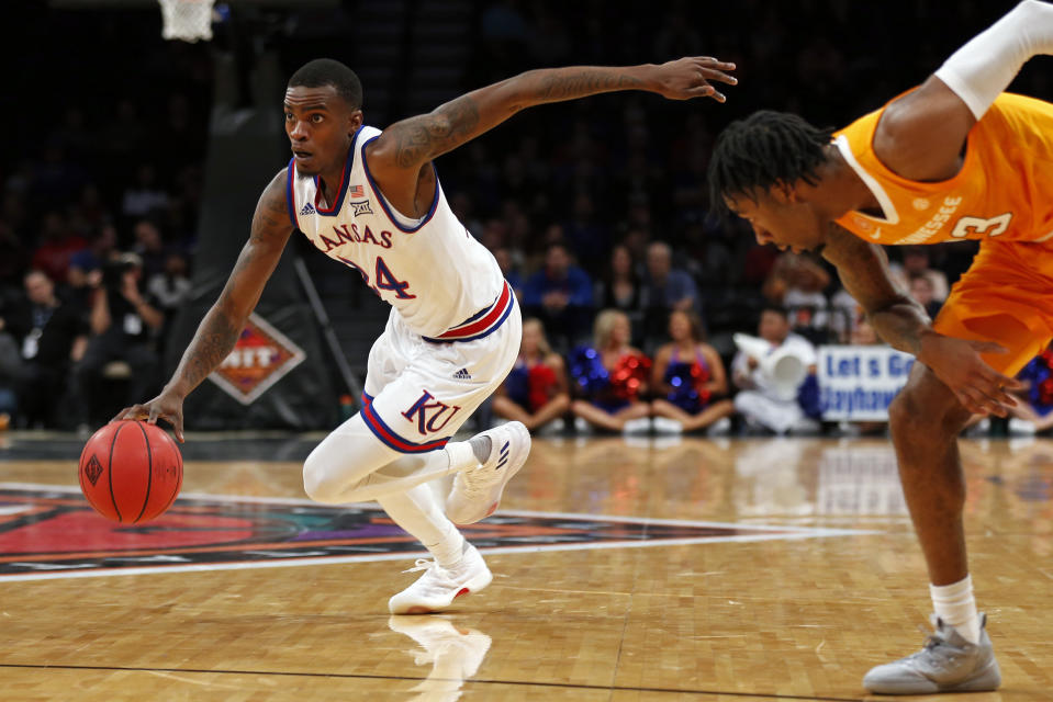 Kansas guard Lagerald Vick (24) drives to the basket past Tennessee guard Jordan Bowden (23) during the first half of an NCAA college basketball game in the NIT Season Tip-Off tournament Friday, Nov. 23, 2018, in New York. (AP Photo/Adam Hunger)