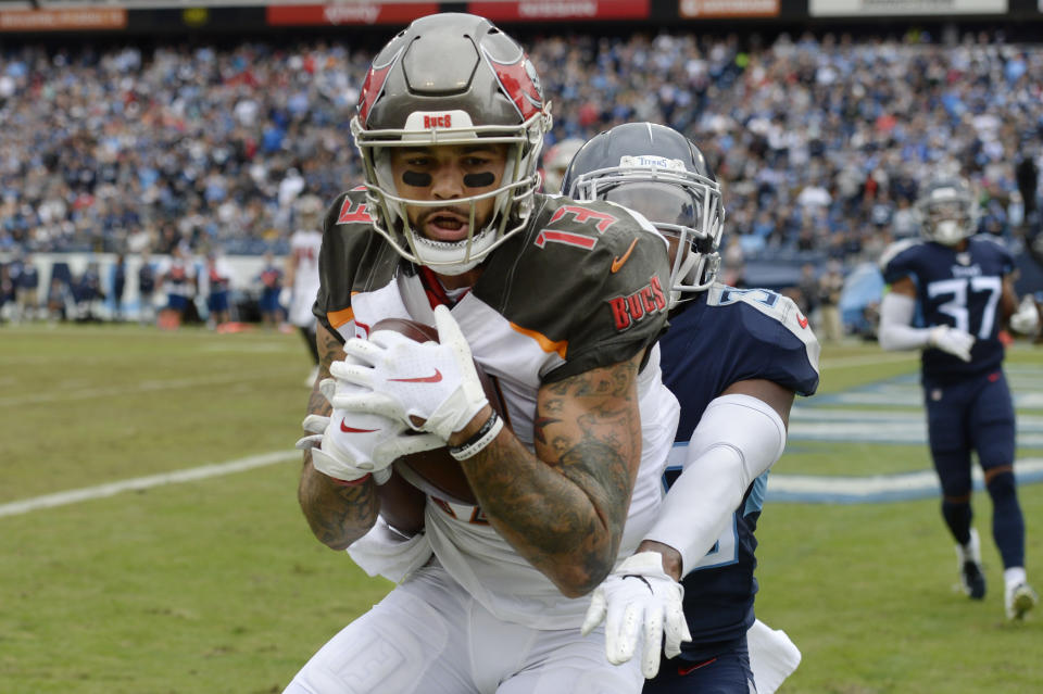 Tampa Bay Buccaneers wide receiver Mike Evans (13) catches a touchdown pass ahead of Tennessee Titans cornerback LeShaun Sims (36) in the first half of an NFL football game Sunday, Oct. 27, 2019, in Nashville, Tenn. (AP Photo/Mark Zaleski)