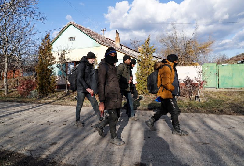 Migrants from Syria walk close to the border with Hungary and Romania in the village of Majdan
