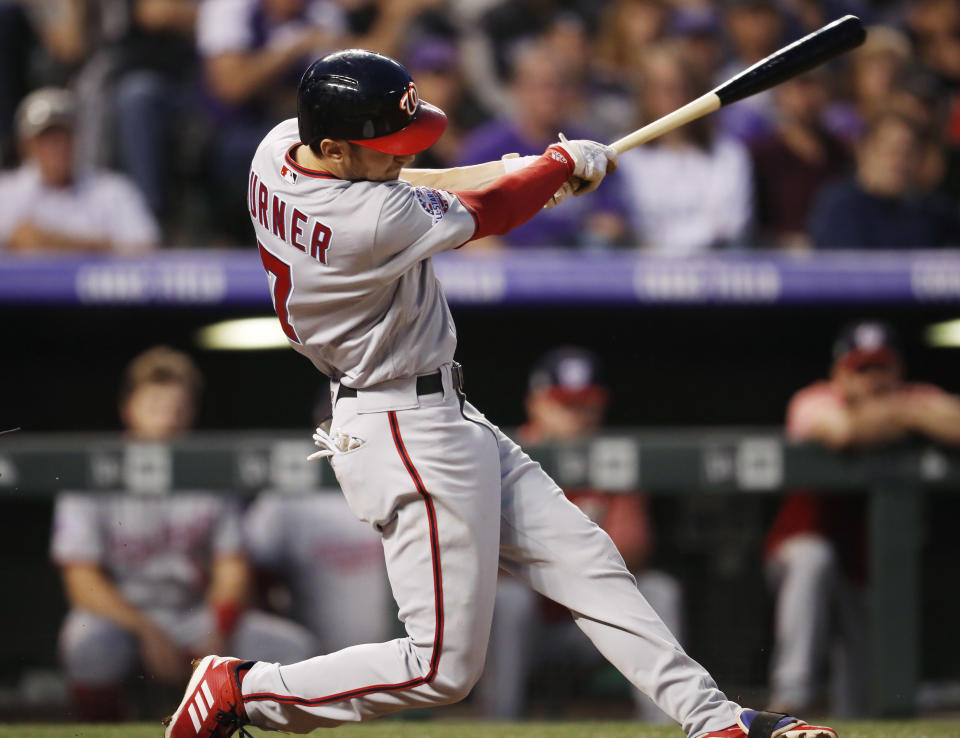 Washington Nationals' Trea Turner follows through with his swing after connecting for a two-run home run off Colorado Rockies starting pitcher Jon Gray in the second inning of a baseball game Saturday, Sept. 29, 2018, in Denver. (AP Photo/David Zalubowski)