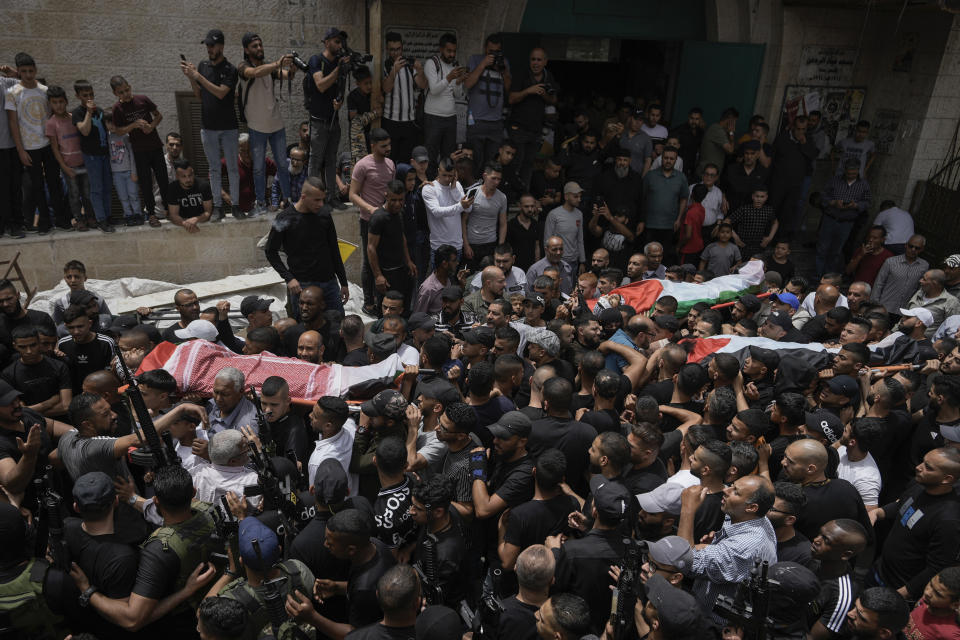 Mourners carry the bodies of three Palestinian militants, Abdullah Abu Hamdan, 24, Muhammad Zaytoun, 32, and Fathi Rizk, 30, during their funeral in the Balata refugee camp near the West Bank town of Nablus Monday, May 22, 2023. The Israeli military raided the camp early Monday, sparking a firefight that killed the three militants. (AP Photo/Majdi Mohammed)