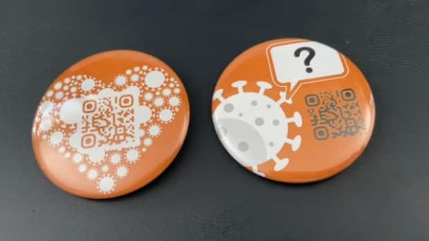 These two buttons, part of what is called The Button Project, are designed to spark conversations about COVID-19 vaccine safety and effectiveness.  (Submitted by The Button Project - image credit)