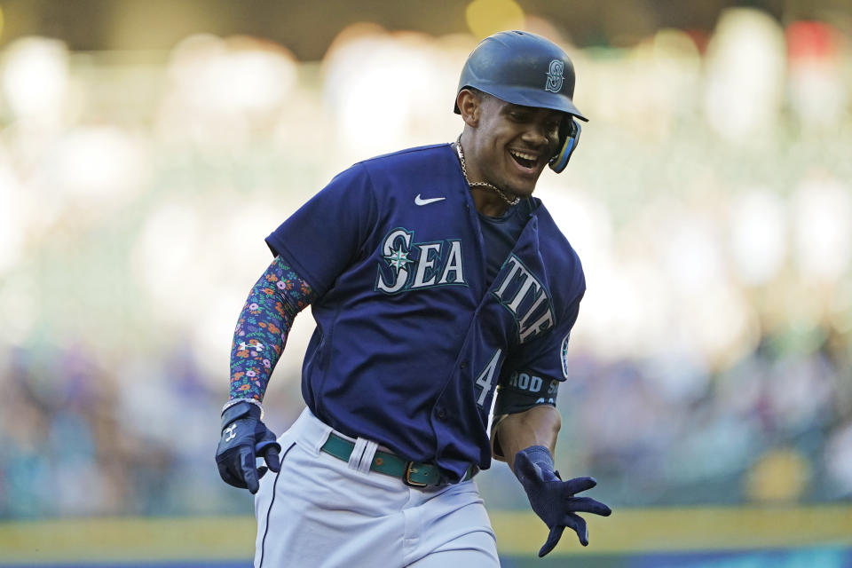 Seattle Mariners' Julio Rodriguez reacts as he rounds the bases after hitting a solo home run against the Texas Rangers during the first inning of a baseball game, Tuesday, July 26, 2022, in Seattle. (AP Photo/Ted S. Warren)