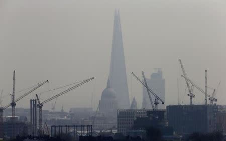 Smog surrounds The Shard, western Europe's tallest building, and St Paul's Cathedral in London April 3, 2014. REUTERS/Suzanne Plunkett