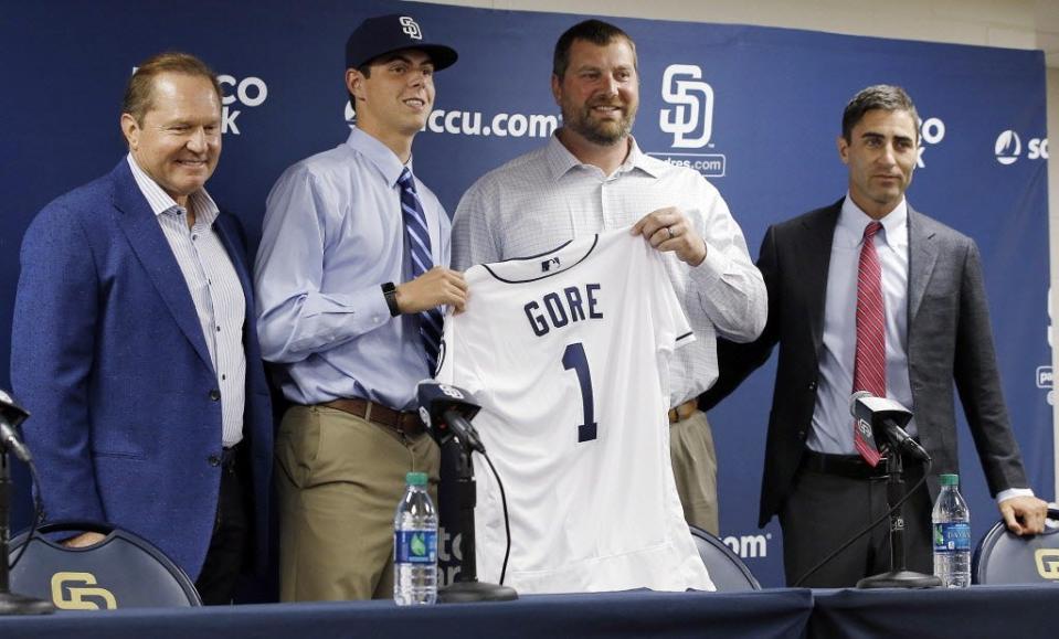 San Diego Padres first-round selection MacKenzie Gore, second from left, poses for a photograph during his introduction, with director of scouting Mark Conner, second from right, executive vice president and general manager A.J. Preller, right, and Gore's agent, Scott Boras, before the Padres' baseball game against the Detroit Tigers in San Diego, Saturday, June 24, 2017. (AP Photo/Alex Gallardo)