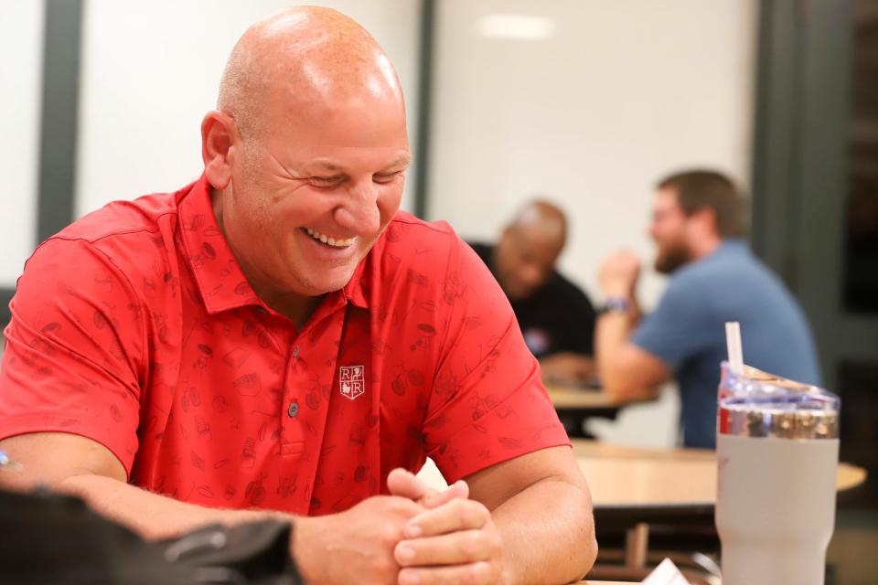 Warren De La Salle head coach Dan Rohn laughs while getting interviewed during the Catholic High School League media day at University of Detroit Jesuit High School and Academy in Detroit on Thursday, July 27, 2023.