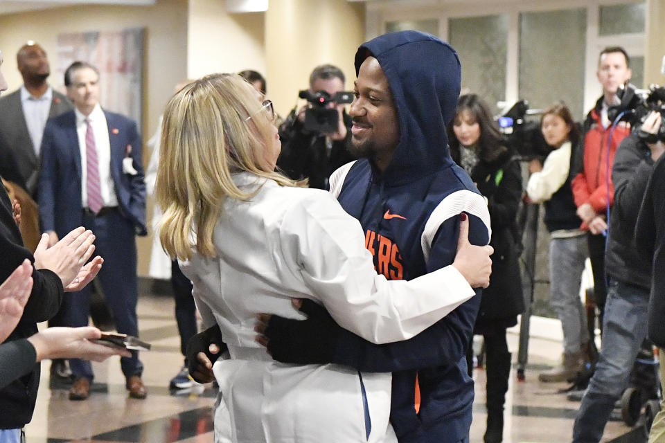 Michelle Bailey, a Neurosurgery Nurse Practitioner with University of Louisville Health Care, left, says goodbye to Perris Jones as he is discharged from the Frazier Rehabilitation Institute in Louisville, Ky., Tuesday, Nov. 28, 2023. Jones, a player on the University of Virginia football team was injured during a game against Louisville on Nov. 9th, and after two and a half weeks is being discharged. (AP Photo/Timothy D. Easley)