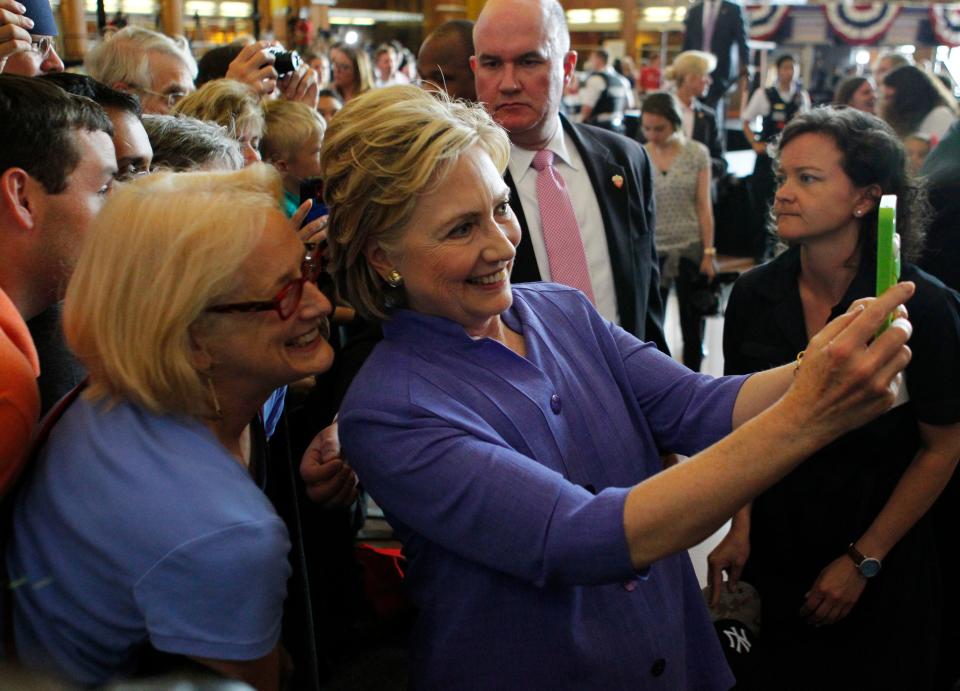 Democratic Presidential candidate Hillary Clinton take selfies with campaign supporters after her speech at campaign rally at the Cincinnati Museum Center at Union Terminal June 27, 2016, in Cincinnati, Ohio.