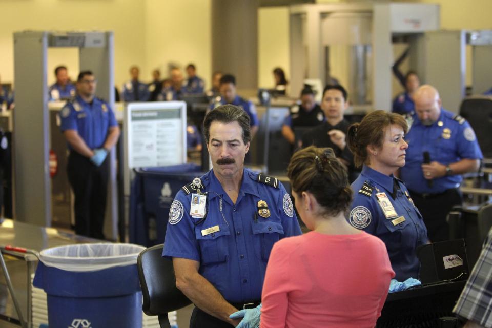 TSA officers pause for a moment of silence for Gerardo Hernandez, the first TSA officer ever killed in the line of duty, in Terminal 3 at Los Angeles airport