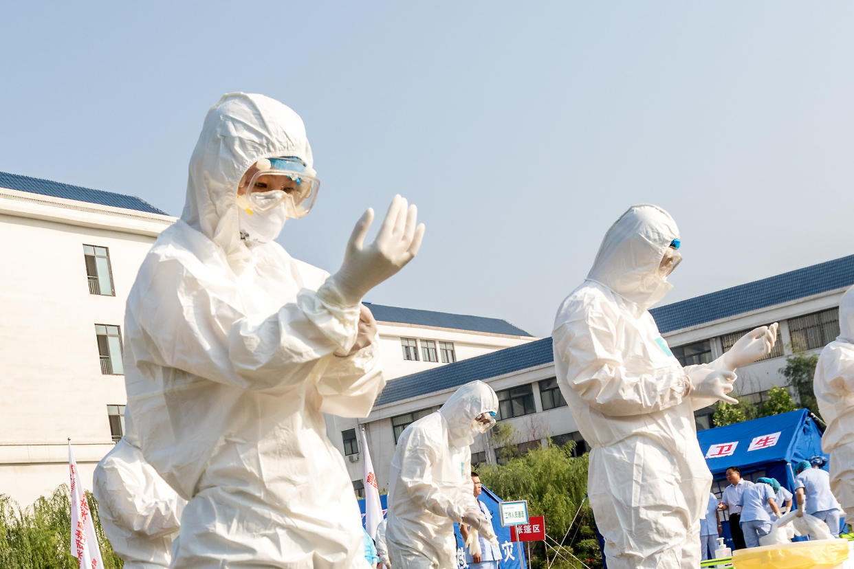 Health workers act in an exercise dealing with an outbreak of H7N9 avian flu on June 17 in Hebi, China. (Photo: Barcroft Media via Getty Images)