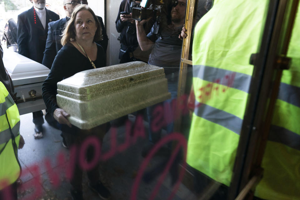 Kathy Whitler holds a child's casket as she attempts to enter the state Capitol as part of the Tennessee Moral Monday rally against gun violence Monday, April 17, 2023, in Nashville, Tenn. (AP Photo/George Walker IV)