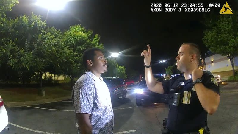 Former Atlanta Police Department officer Garrett Rolfe conducts sobriety test on Rayshard Brooks in a Wendy's restaurant parking lot