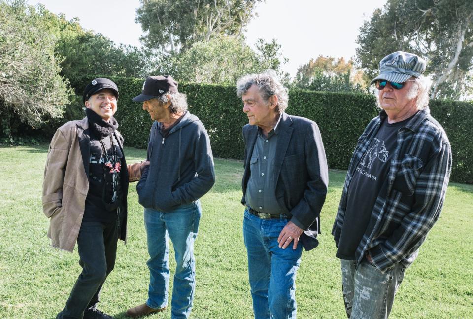 Nils Lofgren (left to right), Ralph Molina and Billy Talboit of Crazy Horse, pictured with Neil Young in 2022.