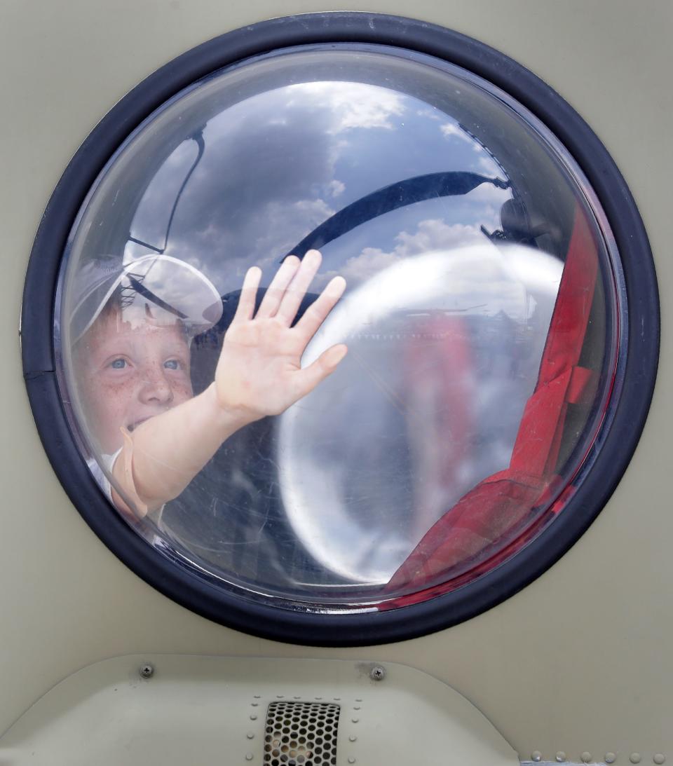 Chirstopher Sahotsky looks out of the window on a Chinook helicopter during the Experimental Aircraft Association AirVenture on Thursday, July 29, 2021, at Wittman Regional Airport in Oshkosh.
