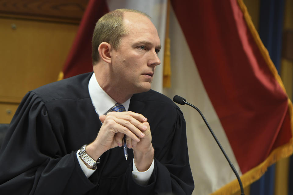 Judge Scott McAfee addresses the lawyers during a hearing on charges against former President Donald Trump in the Georgia election interference case on Thursday, March 28, 2024 in Atlanta. Lawyers for Trump argued in a court filing that the charges against him in the Georgia election interference case seek to criminalize political speech and advocacy conduct that is protected by the First Amendment. (Dennis Byron/Hip Hop Enquirer via AP)