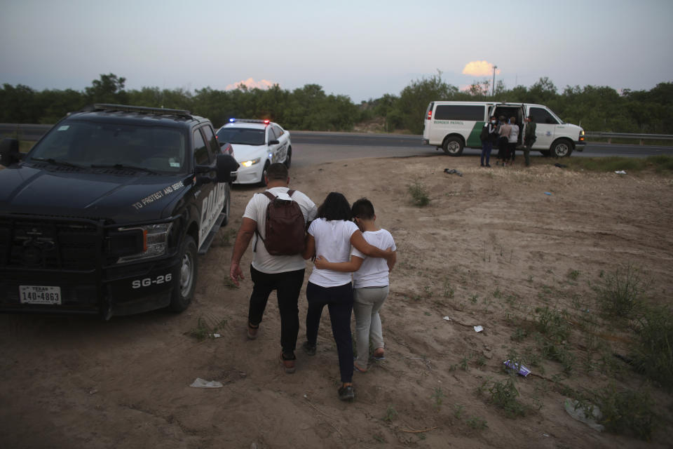 FILE - A migrant family who earlier crossed the Rio Grande river into the United States is taken away by Border Patrol agents in Eagle Pass, Texas, Saturday, May 21, 2022. The Eagle Pass area has become increasingly a popular crossing corridor for migrants, especially those from outside Mexico and Central America, under Title 42 authority, which expels migrants without a chance to seek asylum on grounds of preventing the spread of COVID-19. (AP Photo/Dario Lopez-Mills)