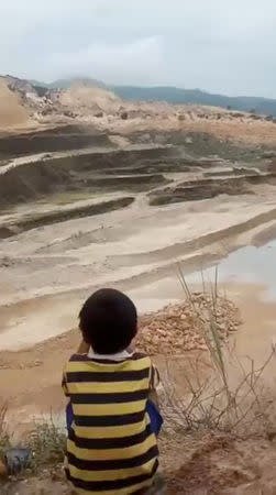 People are seen in an area after a landslide in the City of Naga, Cebu, Philippines September 20, 2018, in this still image taken from a social media video. SAM MOCHA UY/via REUTERS