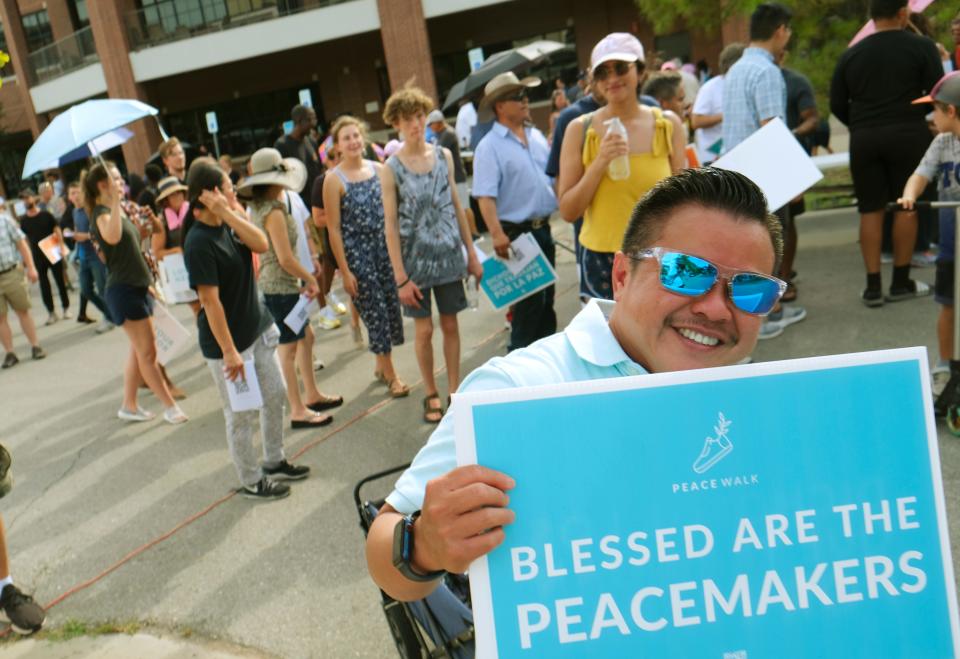 Thuan Nguyen leads a group out of Catholic Charities' parking lot on Sunday, Aug. 7, 2022, during the Peace Walk through OKC's Asian District.