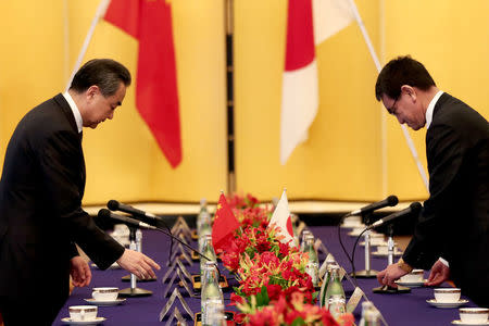 Chinese State Councilor and Foreign Minister Wang Yi (L) and Japan's Foreign Minister Taro Kono meet in Tokyo, Japan April 15, 2018. Behrouz Mehri/Pool via Reuters