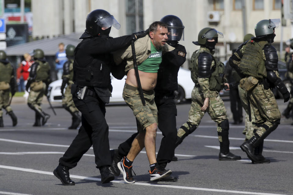 Riot police officers detain a protester during a Belarusian opposition supporters' rally protesting the official presidential election results in Minsk, Belarus, Sunday, Sept. 13, 2020. More than 100,000 demonstrators calling for the authoritarian president's resignation marched in the Belarusian capital on Sunday as the daily protests that have gripped the nation entered their sixth week. (AP Photo)