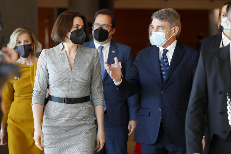 Belarusian opposition leader Sviatlana Tsikhanouskaya arrives with European Parliament President David Sassoli before addressing the European Parliament in Strasbourg, eastern France, Wednesday, Nov.24, 2021. (AP Photo/Jean-Francois Badias)