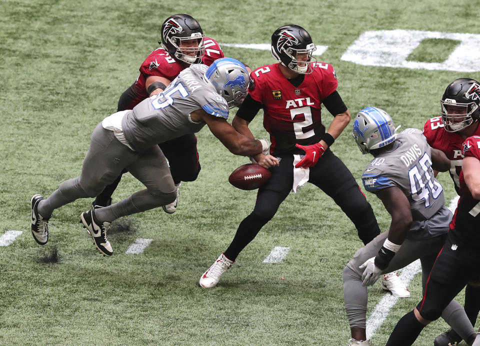 Detroit Lions defensive end Romeo Okwara, bottom left, gets past Atlanta Falcons tackle Jake Matthews, top left, to strip sack Falcons quarterback Matt Ryan (2) during the fourth quarter of an NFL football game Sunday, Oct. 25, 2020, in Atlanta. The Lions recovered the ball. (Curtis Compton/Atlanta Journal-Constitution via AP)