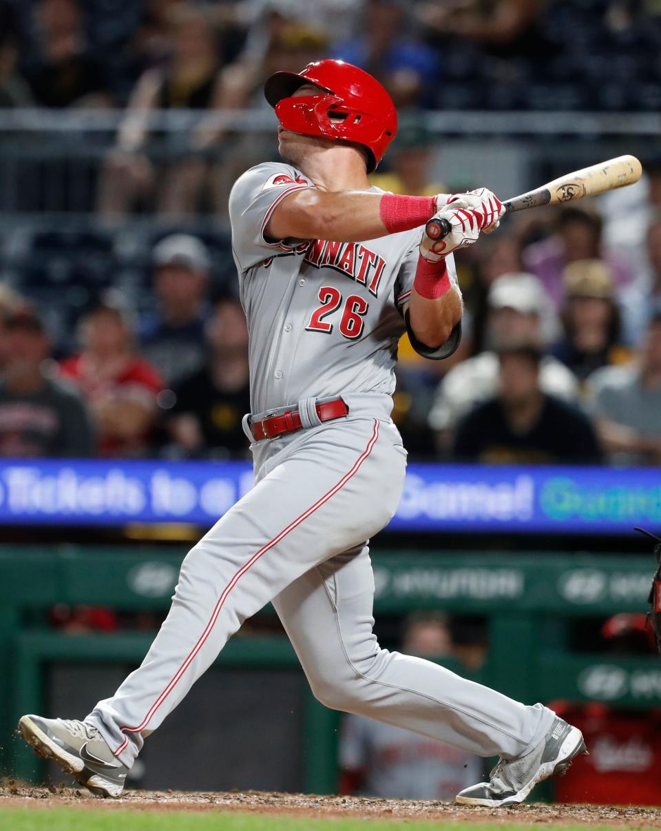 Cincinnati Reds right fielder TJ Hopkins (26) hits a single against the Pittsburgh Pirates during the tenth inning at PNC Park in Pittsburgh on Aug. 13, 2023. The Reds won 6-5 in ten innings.