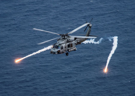 A U.S. Navy MH-60R Sea Hawk helicopter from the "Blue Hawks" of Helicopter Maritime Strike Squadron 78 fires chaff flares during a training exercise near the aircraft carrier USS Carl Vinson (CVN 70) in the Philippine Sea April 24, 2017. U.S. Navy/Mass Communication Specialist 2nd Class Sean M. Castellano/Handout via REUTERS