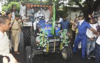 RJD leader Tejashwi Yadav rides a tractor along with party supporters during 'Bharat Bandh', a protest against the farm bills passed in Parliament recently, in Patna, Friday, Sept. 25, 2020. (PTI Photo)