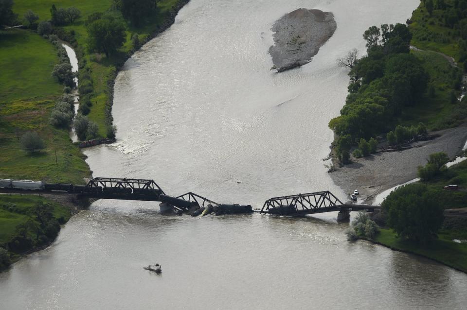 Portions of a freight train are seen in the Yellowstone River after an overnight railroad bridge collapse, near Columbus, Mont., Saturday, June 24, 2023. (AP)