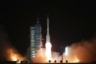 In this photo released by Xinhua News Agency, the manned spaceship Shenzhou-15, atop the Long March-2F Y15 carrier rocket, blasts off from the Jiuquan Satellite Launch Center in northwestern China on Tuesday, Nov. 29, 2022. China launched the rocket Tuesday carrying three astronauts to complete construction of the country's permanent orbiting space station. (Li Gang/Xinhua via AP)