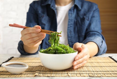 <span class="caption">Sea vegetables, such as Japanese seaweed, are packed full of nutrients.</span> <span class="attribution"><a class="link " href="https://www.shutterstock.com/image-photo/woman-eating-japanese-seaweed-salad-table-1938029617" rel="nofollow noopener" target="_blank" data-ylk="slk:New Africa/ Shutterstock;elm:context_link;itc:0;sec:content-canvas">New Africa/ Shutterstock</a></span>