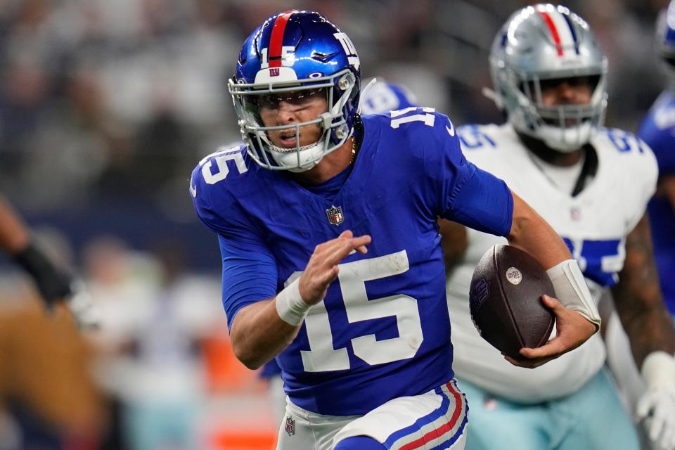 New York Giants quarterback Tommy DeVito (15) scrambles in the second half of an NFL football game against the Dallas Cowboys, Sunday, Nov. 12, 2023, in Arlington, Texas. (AP Photo/Julio Cortez)