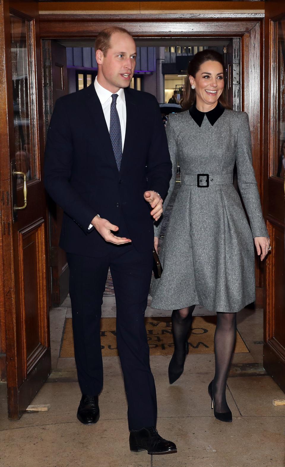 Prince William and Duchess Kate of Cambridge arrive for the UK Holocaust Memorial Day Commemorative Ceremony in Westminster on Jan. 27, 2020 in London. She wore a grey dress belted at the waist with black velvet collar and black accessories.