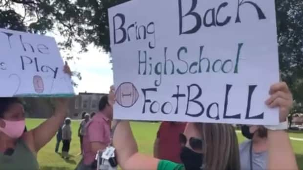 Students and parents made their voice heard outside of Kennedy High School Aug. 30. They were protesting the cancellation of high school football for the 2021 season.  (Dale Molnar/CBC - image credit)