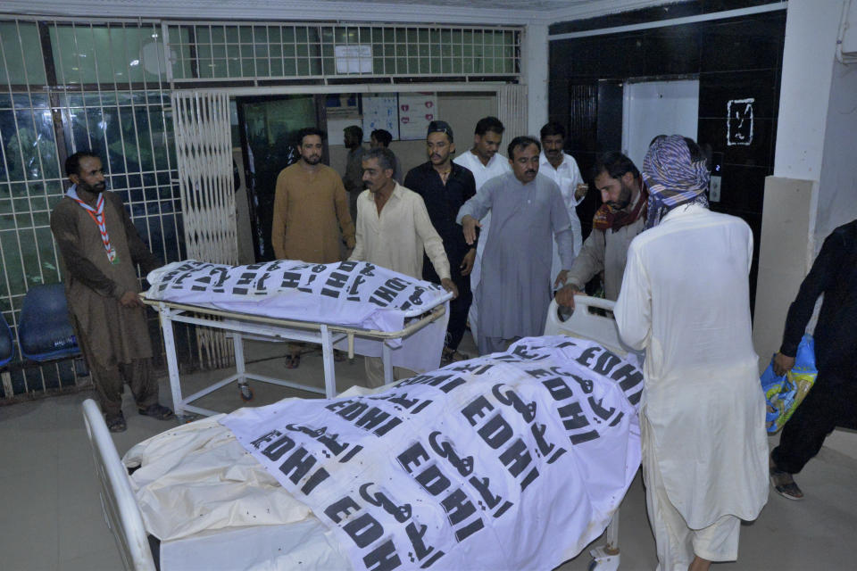 People receives bodies of their relative, who were died in a passenger train derailed incident, at a hospital, in Nawabshah, Pakistan, Sunday, Aug. 6, 2023. Railway officials say some passengers were killed and dozens more injured when a train derailed near the town of Nawabshah in southern Sindh province. (AP Photo/Pervez Masih)