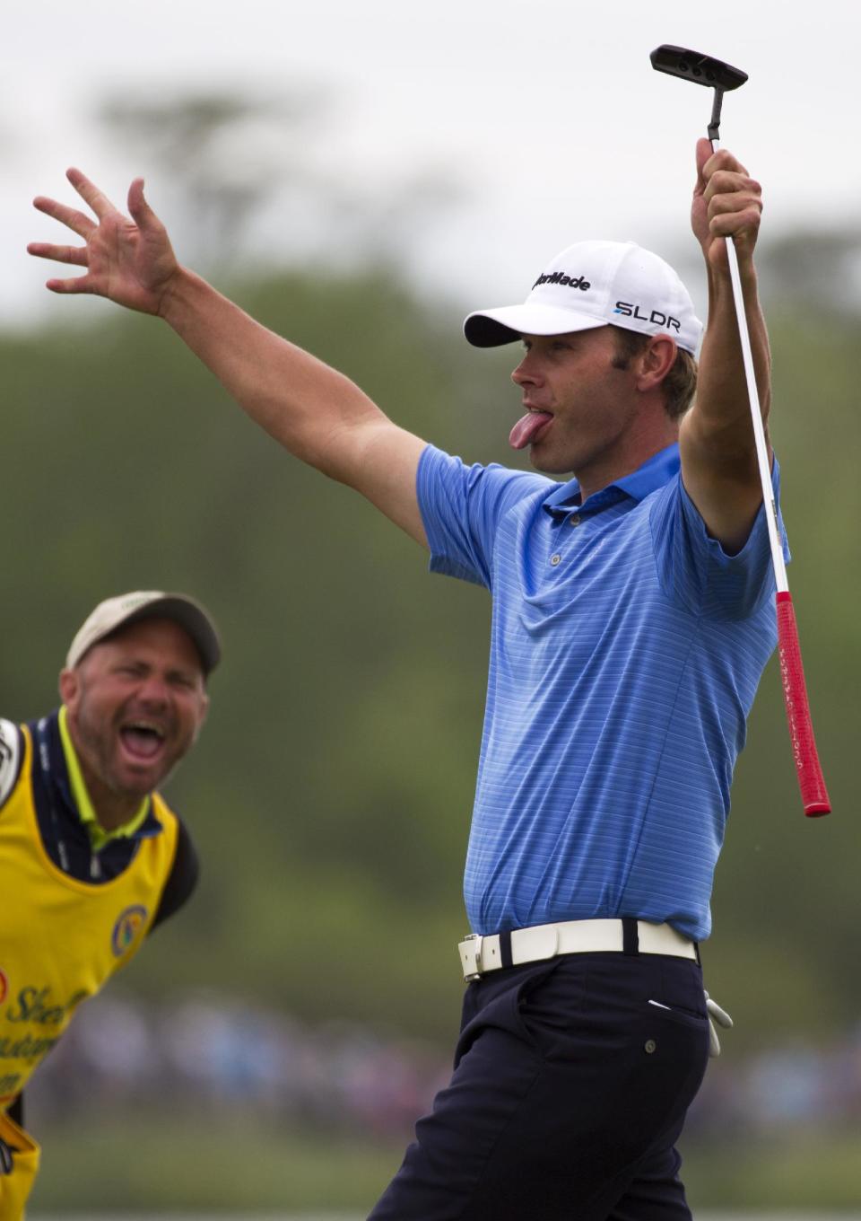 Shawn Stefani, right, celebrates after sinking in a birdie on the eighteenth hole during the third round of the Houston Open golf tournament on Saturday, April 5, 2014, in Humble, Texas. (AP Photo/Patric Schneider)
