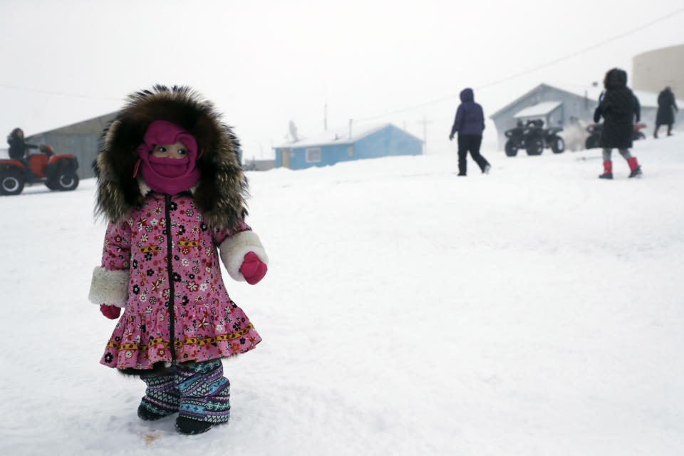 A girl waits for her mother, Sunday, Jan. 19, 2020, in Toksook Bay, Alaska. The first Americans to be counted in the 2020 Census starting Tuesday, Jan. 21, live in this Bering Sea coastal village. The Census traditionally begins earlier in Alaska than the rest of the nation because frozen ground allows easier access for Census workers, and rural Alaska will scatter with the spring thaw to traditional hunting and fishing grounds. (AP Photo/Gregory Bull)