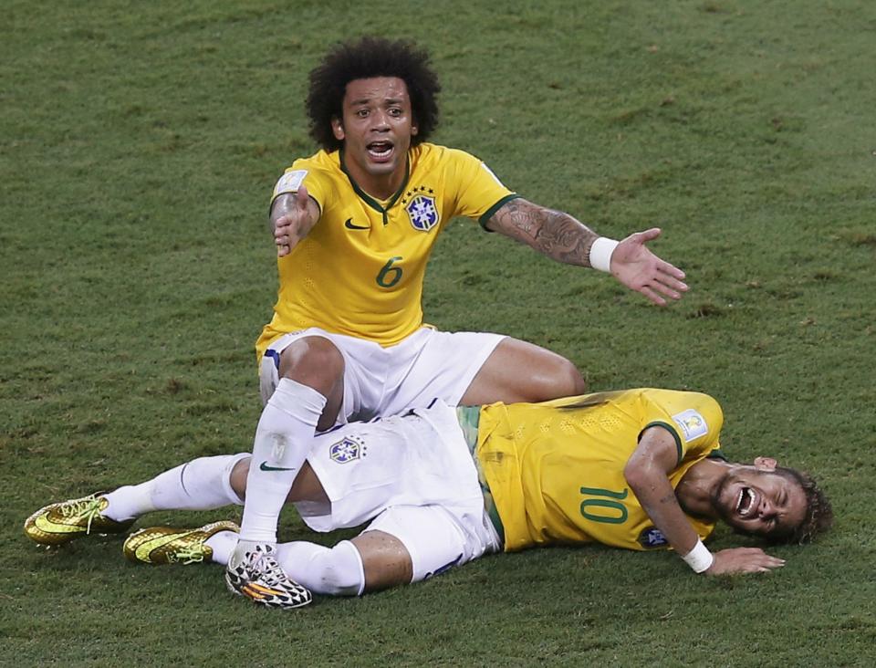 Brazil's Marcelo gestures over his injured teammate Neymar, who was fouled by Colombia's Camilo Zuniga (not pictured) during their 2014 World Cup quarter-finals at the Castelao arena in Fortaleza July 4, 2014. REUTERS/Leonhard Foeger