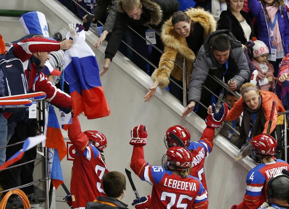 Russian players are congratulated by fans as they leave the ice after they defeated Germany in their women's ice hockey game at the 2014 Sochi Winter Olympics, February 9, 2014. REUTERS/Grigory Dukor (RUSSIA - Tags: SPORT OLYMPICS SPORT ICE HOCKEY)