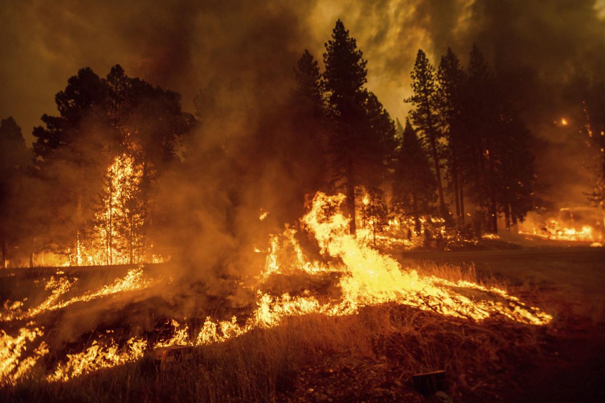 Flames from the Dixie Fire spread through the Greenville community of Plumas County, Calif. on Wednesday, Aug. 4, 2021.