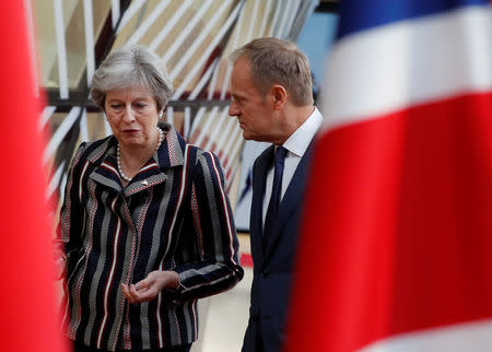 European Council President Donald Tusk and Britain's Prime Minister Theresa May talk as they arrive for a group photo at the ASEM leaders summit in Brussels, Belgium October 19, 2018. REUTERS/Yves Herman/Files