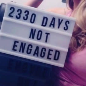 Woman's sign on how many days she hasn't been engaged